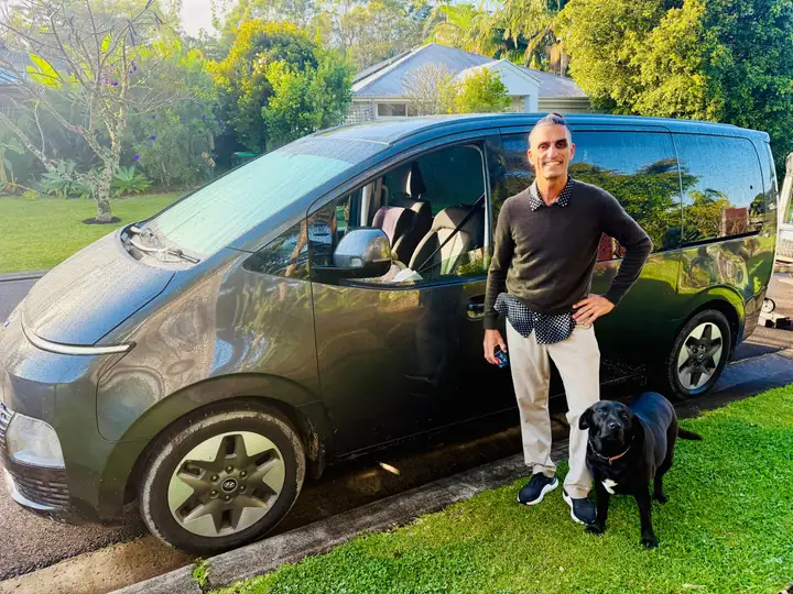 Todd, owner of Byron Shuttle Bus, with the van in Byron Bay